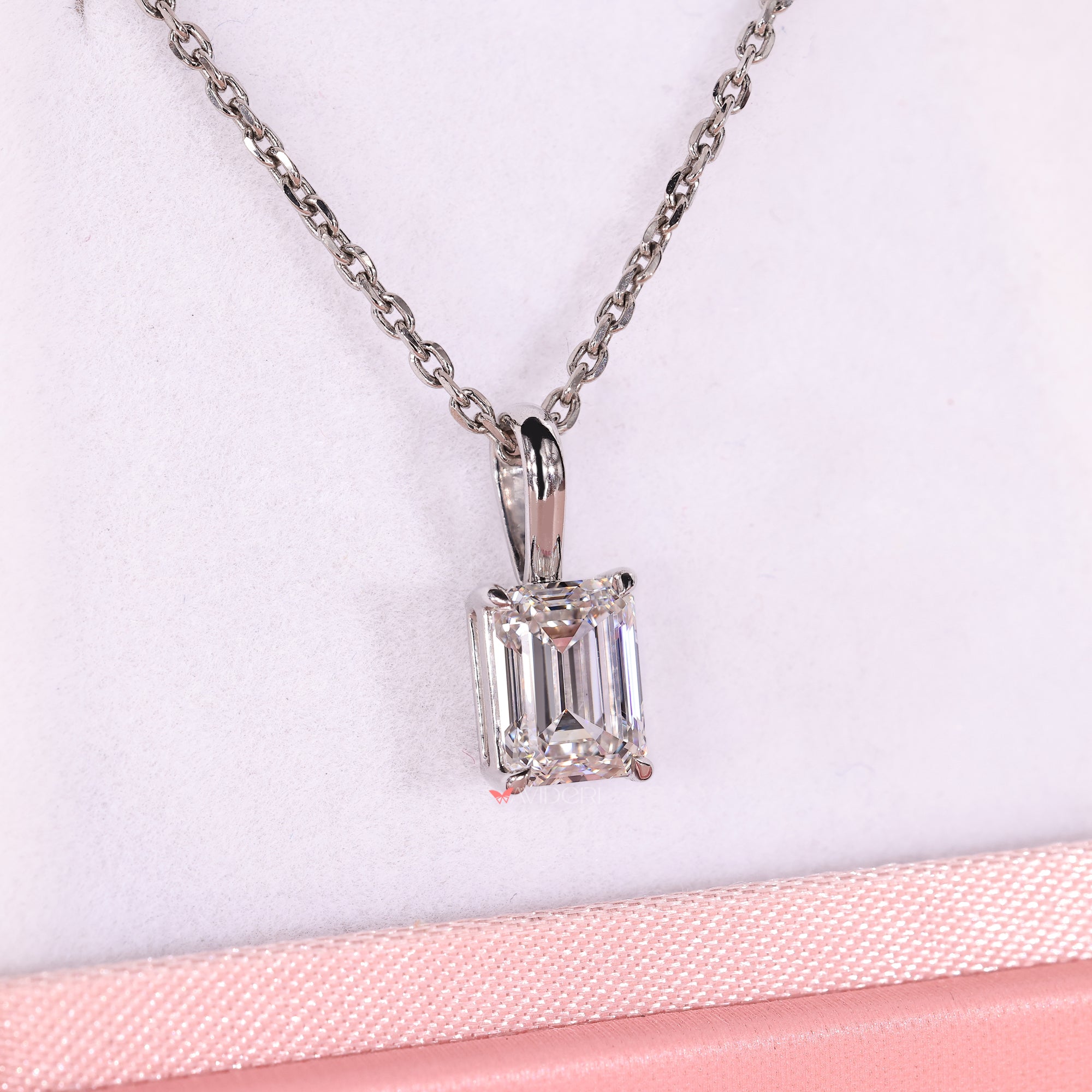 Lab grown emerald cut diamond pendant in claw prong design.