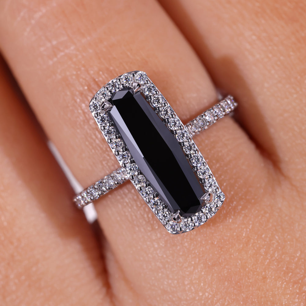 Cathedral setting engagement ring with elongated cushion cut and pave details.
