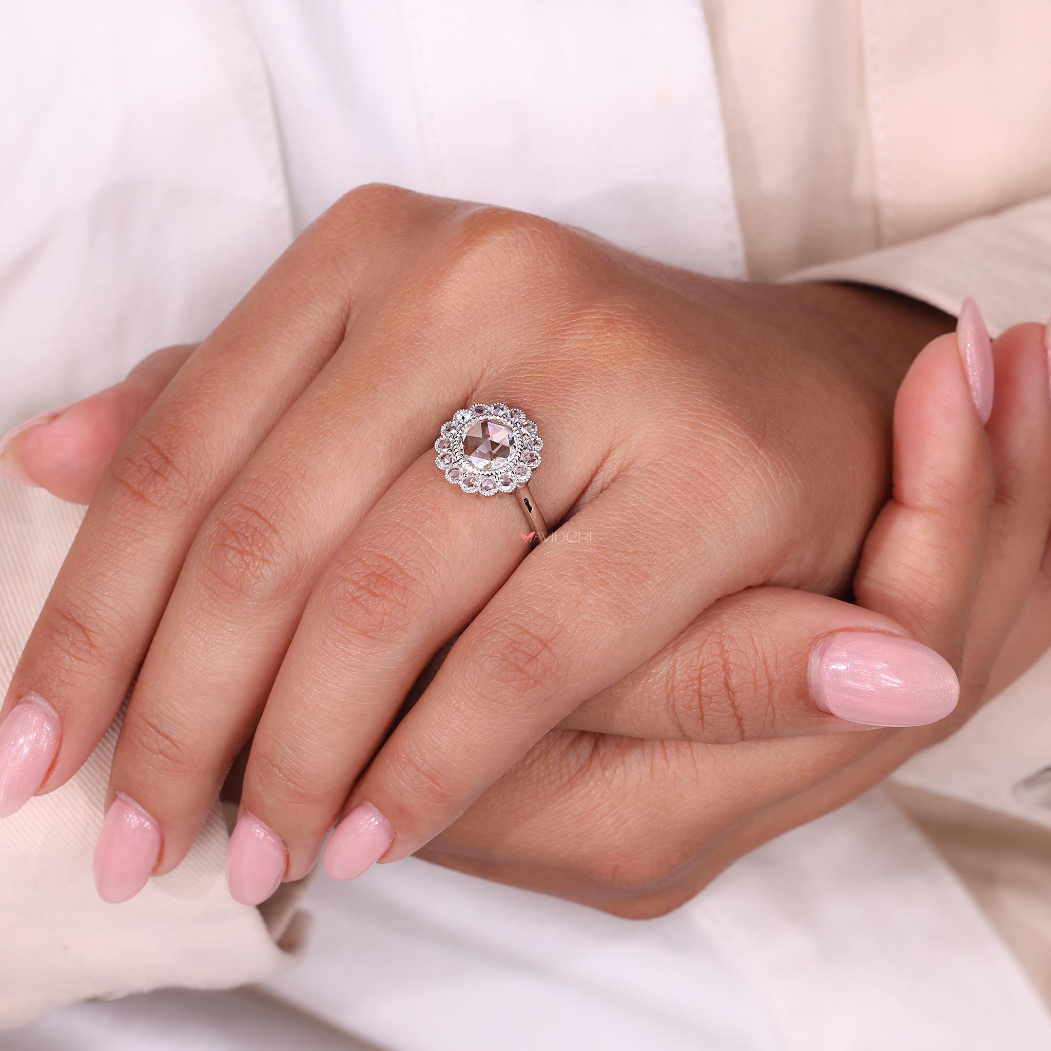 Halo Diamond Ring featuring a round rose cut diamond surrounded by smaller diamonds.