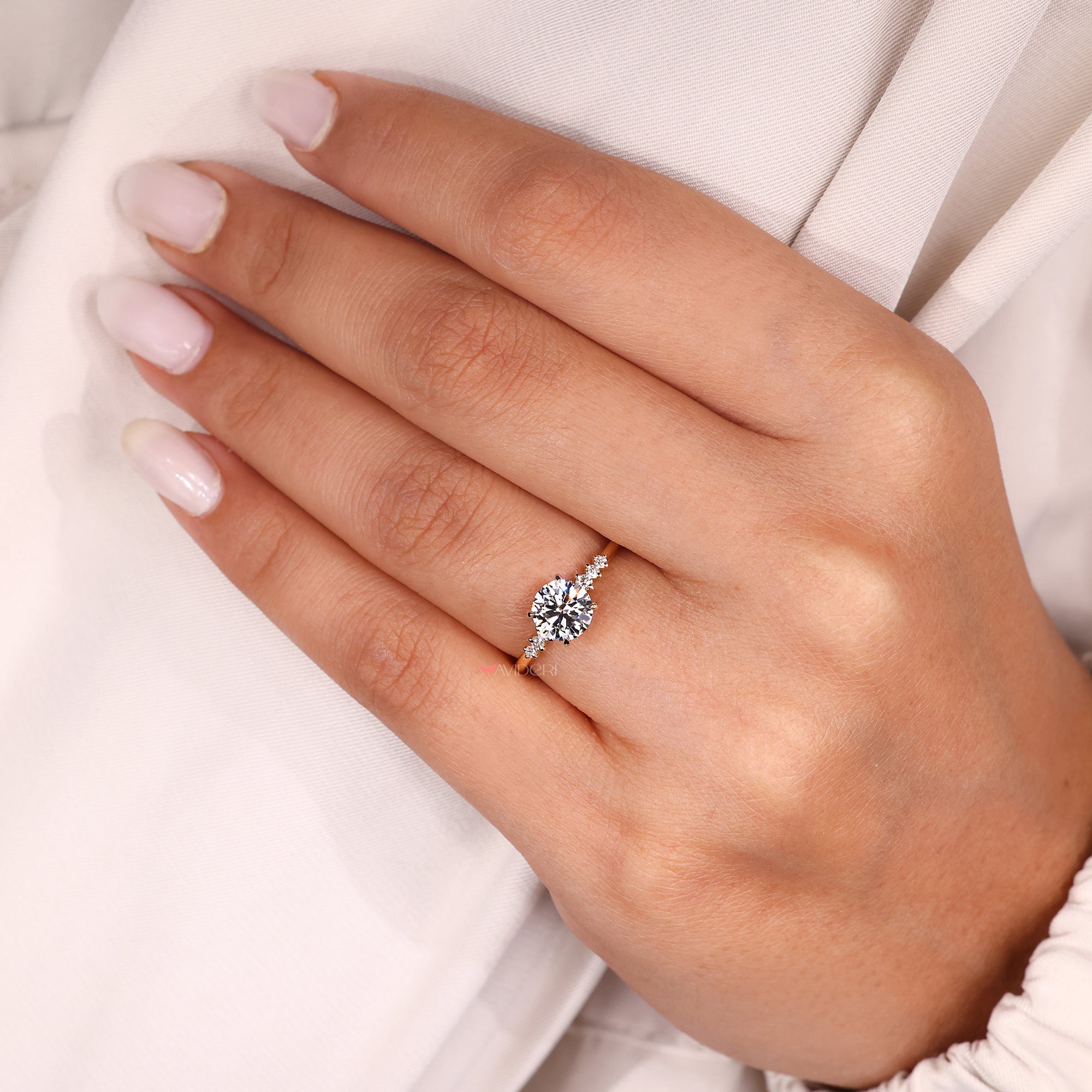 Custom seven stone ring with round side diamonds.