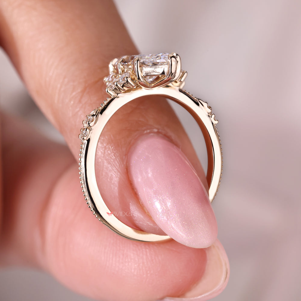Vintage Diamond Ring with a marquise cut diamond set in a detailed yellow gold band.