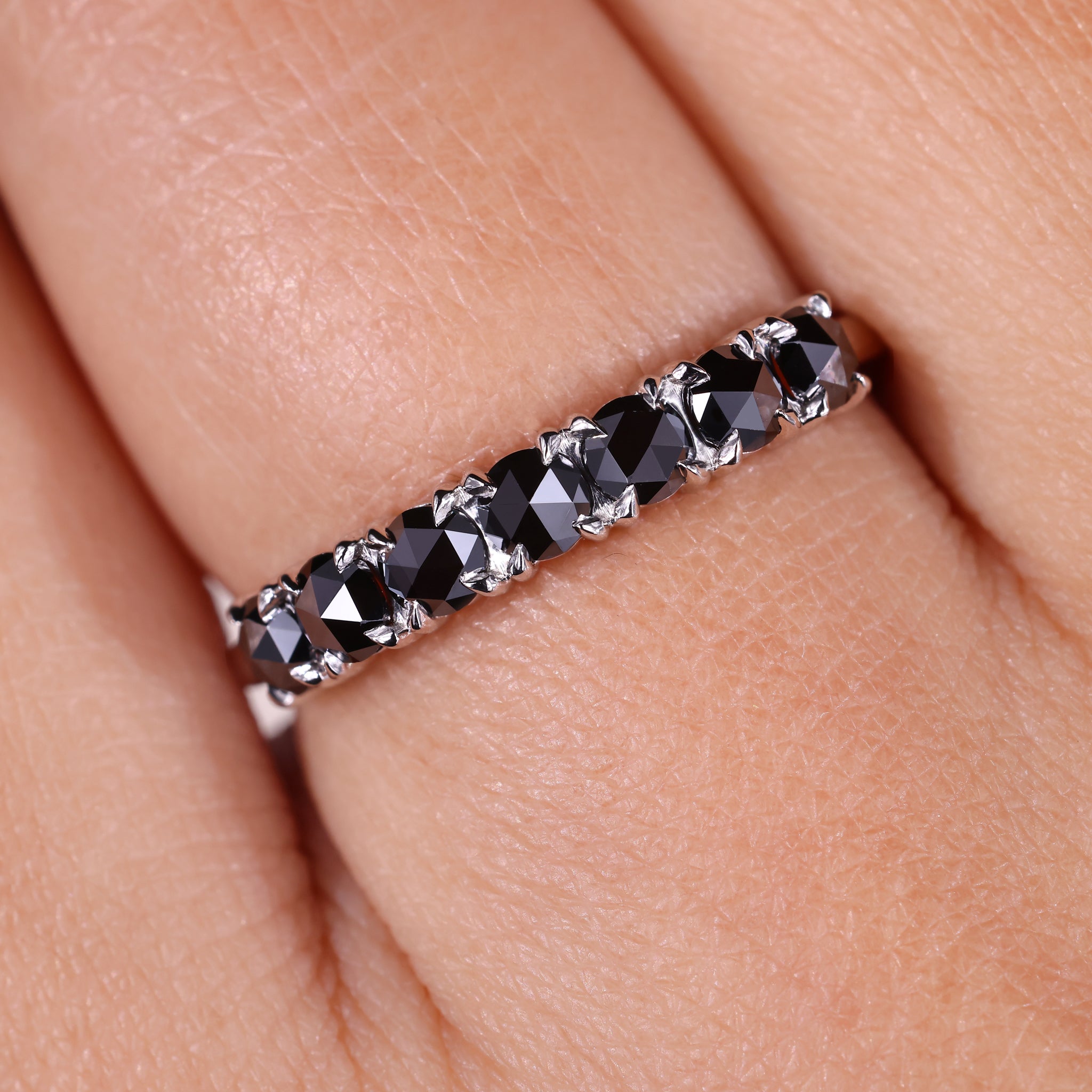 A black moissanite wedding band shines with bold elegance.