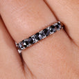 A black moissanite wedding band shines with bold elegance.