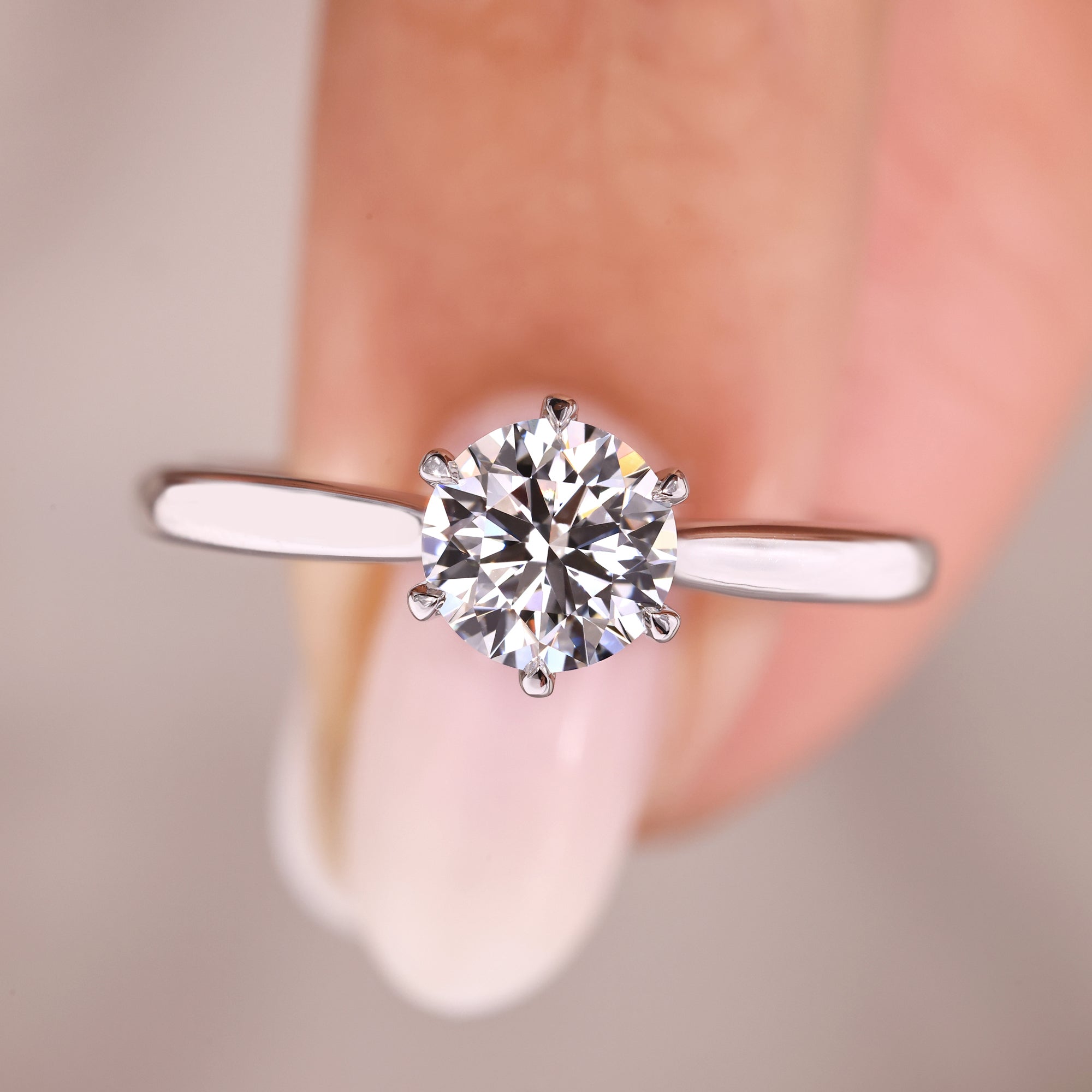 Classic solitaire diamond ring with tapered band.