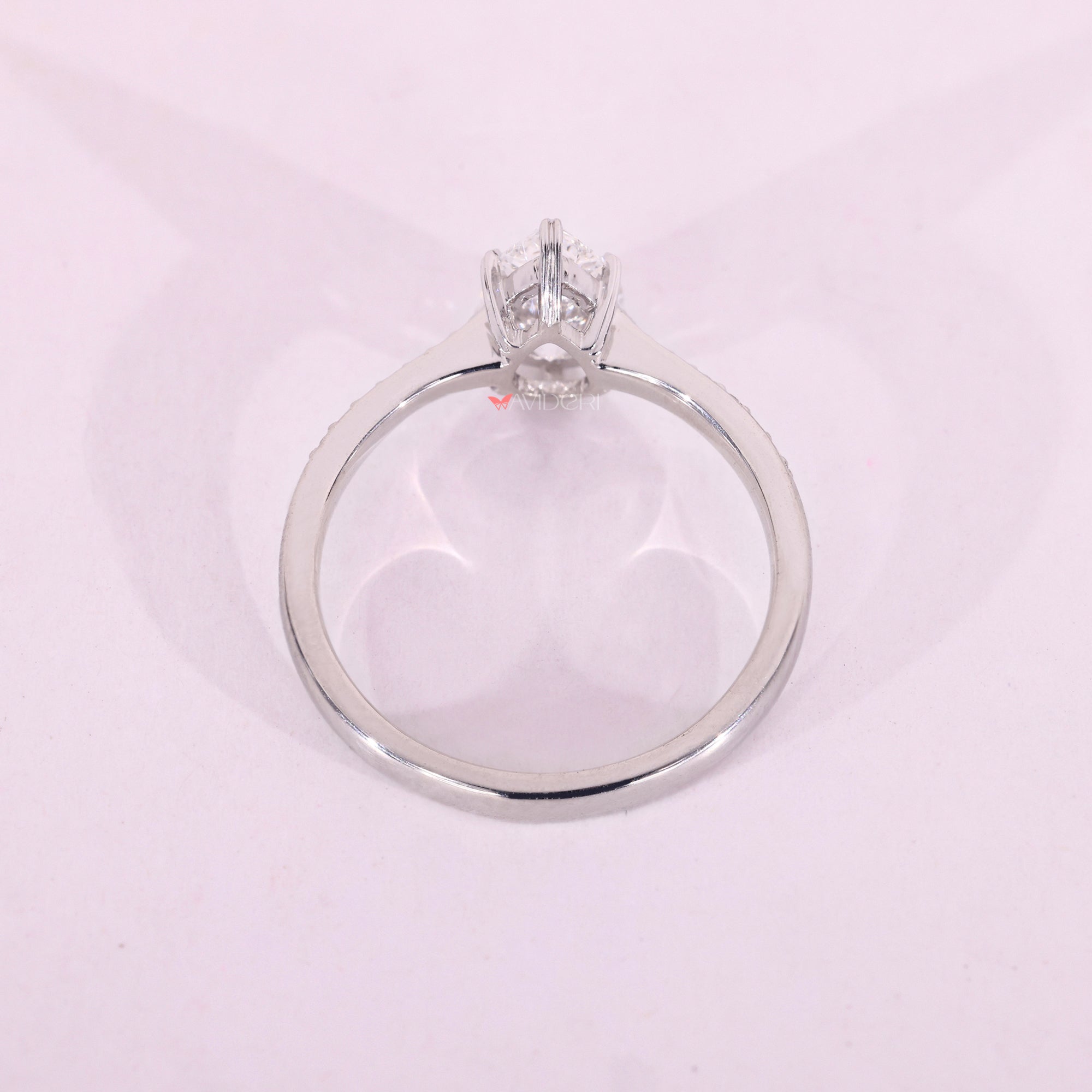 White gold ring with pear and round diamonds.