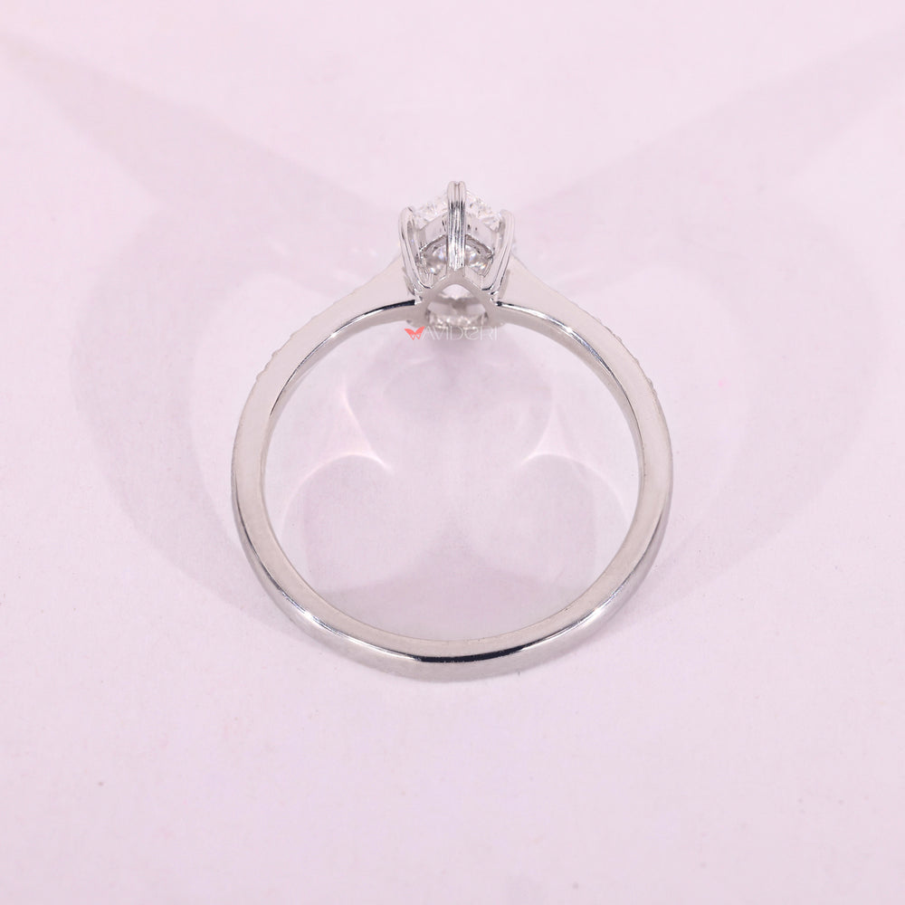 White gold ring with pear and round diamonds.