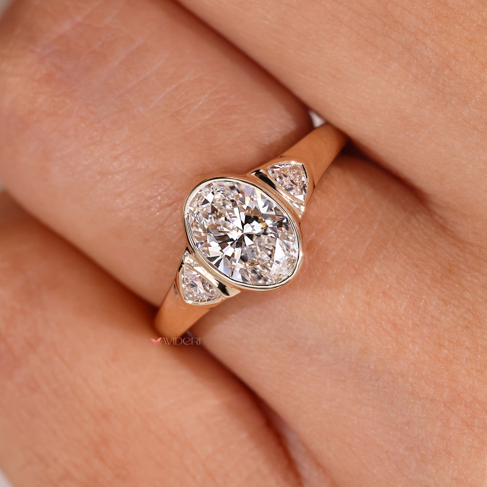 Custom engagement ring with three stone layout.