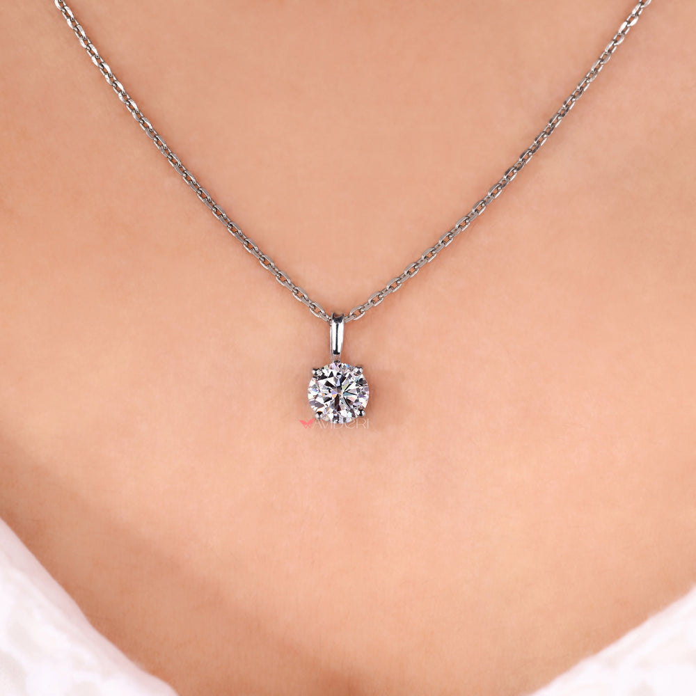 Solitaire moissanite pendant with claw prongs.