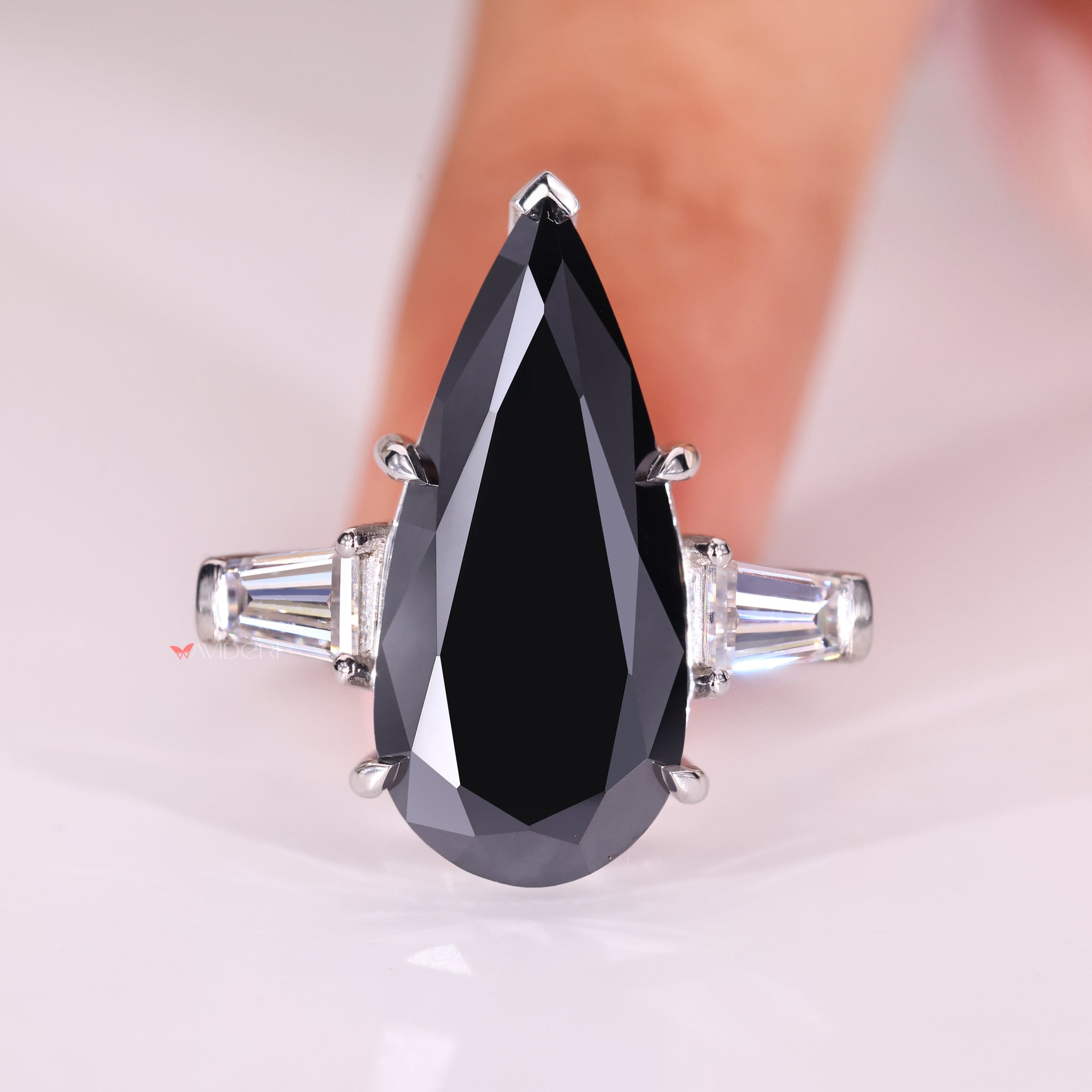 gifts for women featuring pear cut moissanite ring with v-prong setting.