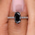 Moval cut moissanite engagement ring with a solitaire setting on a sleek band.
