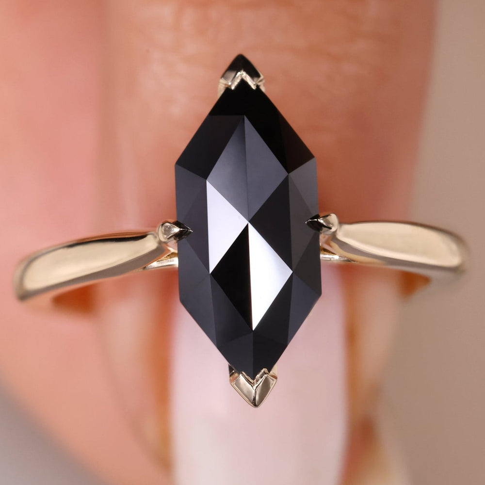 A solitaire engagement ring featuring a classic rose cut stone.
