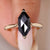 A solitaire engagement ring featuring a classic rose cut stone.
