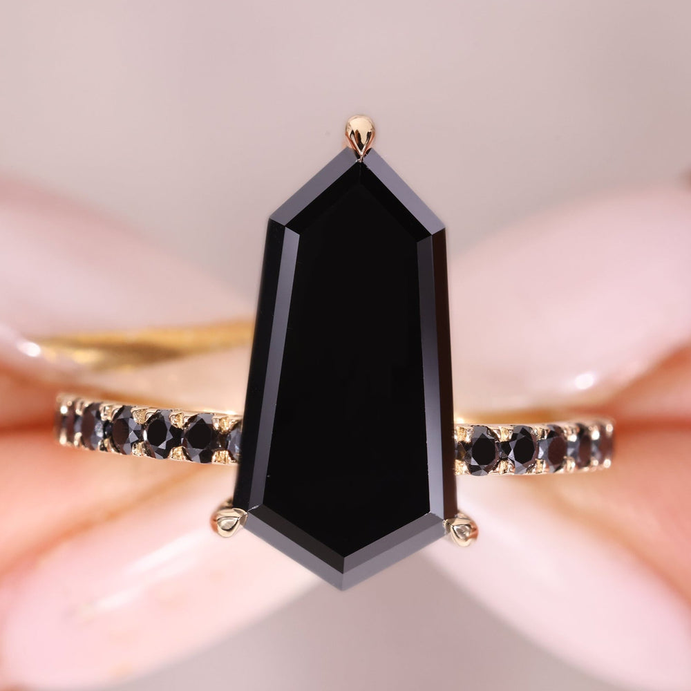 Shield cut engagement ring with a bold black moissanite center.
