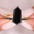 Shield cut engagement ring with a bold black moissanite center.
