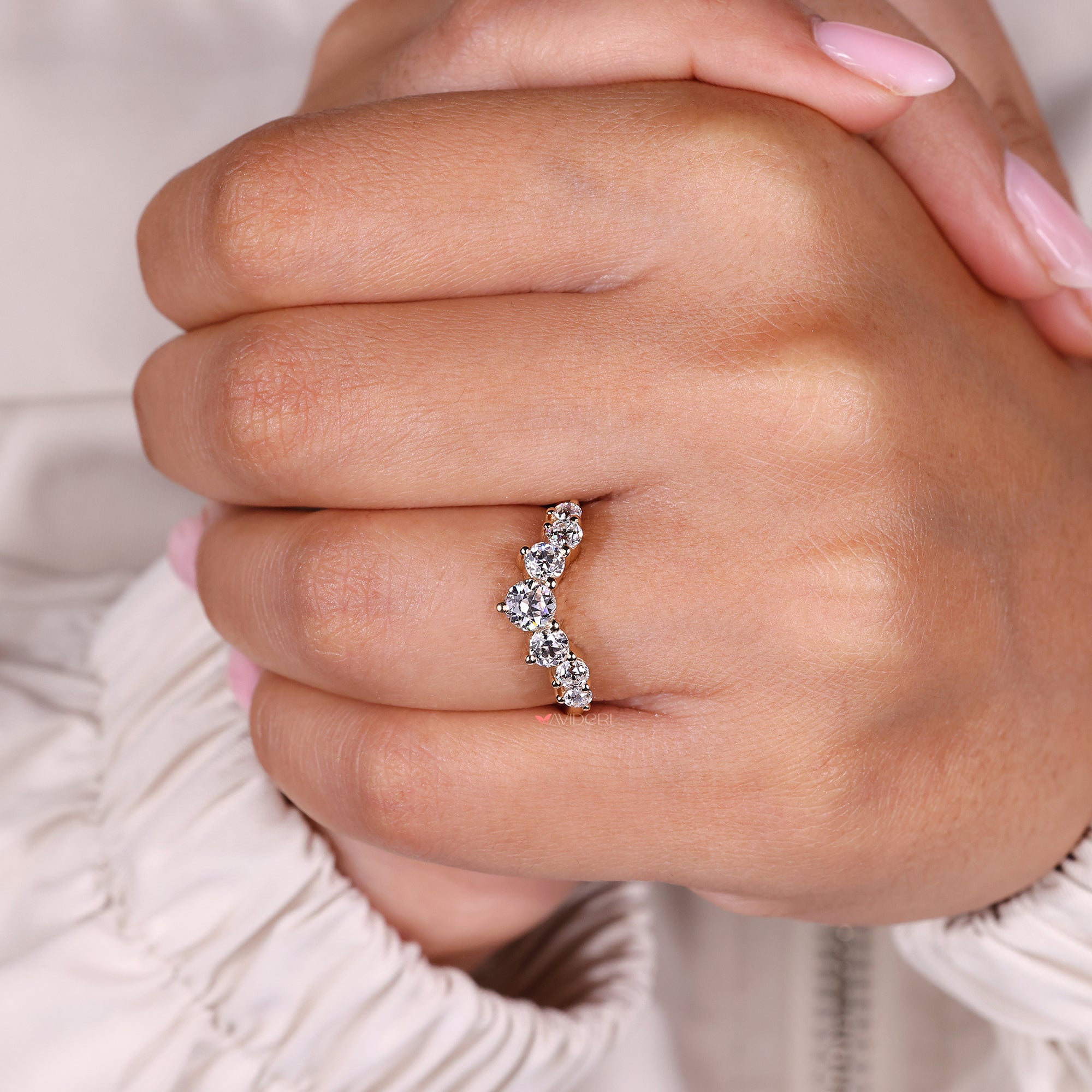 Curvy wedding band has smooth, curved shape.