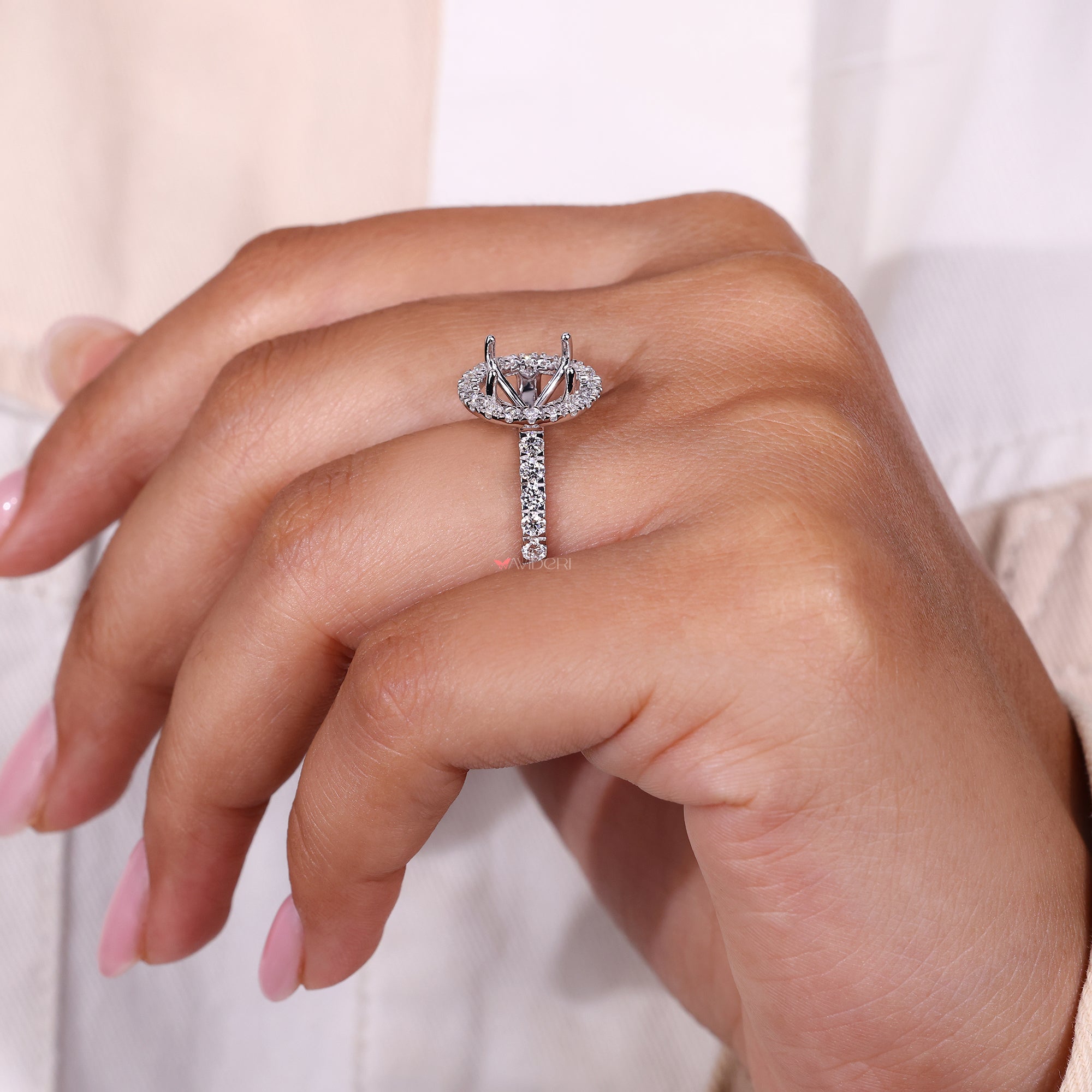 Handmade ring featuring round diamond halo setting.
