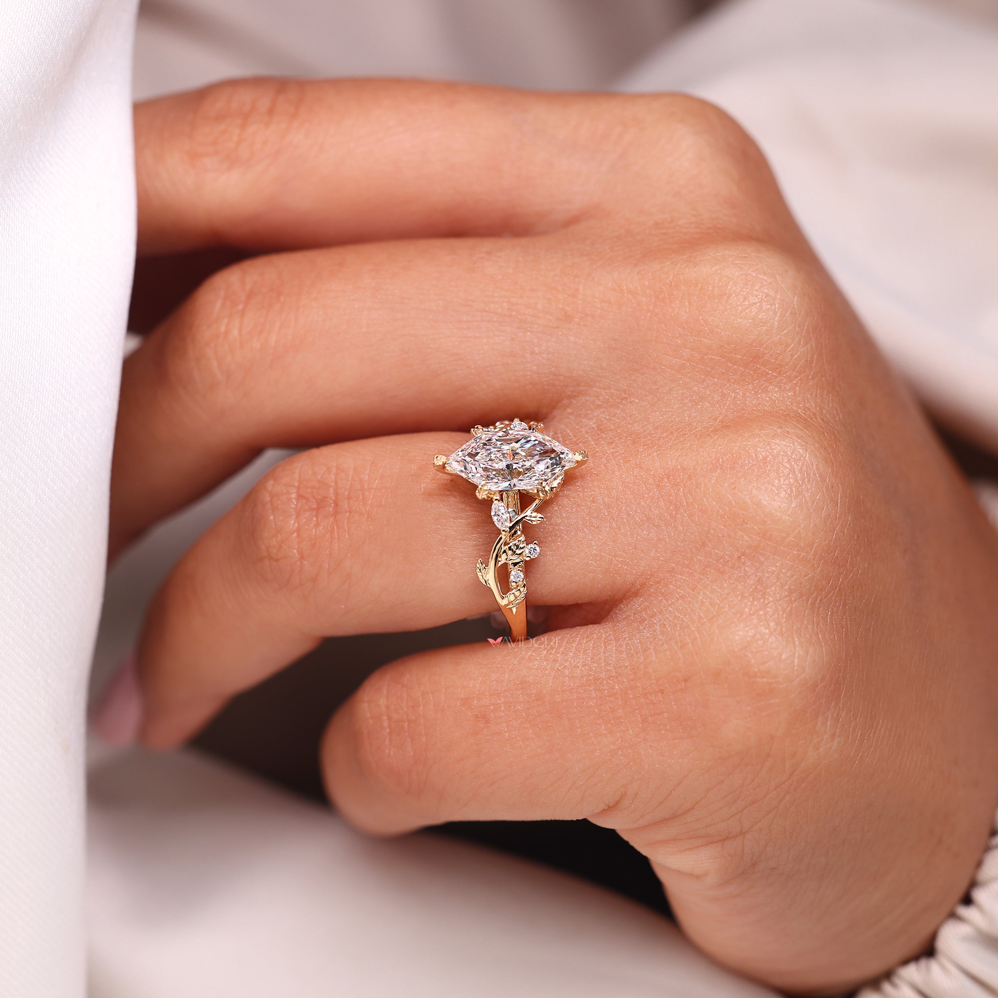Leaf style prong setting in diamond cluster engagement ring.