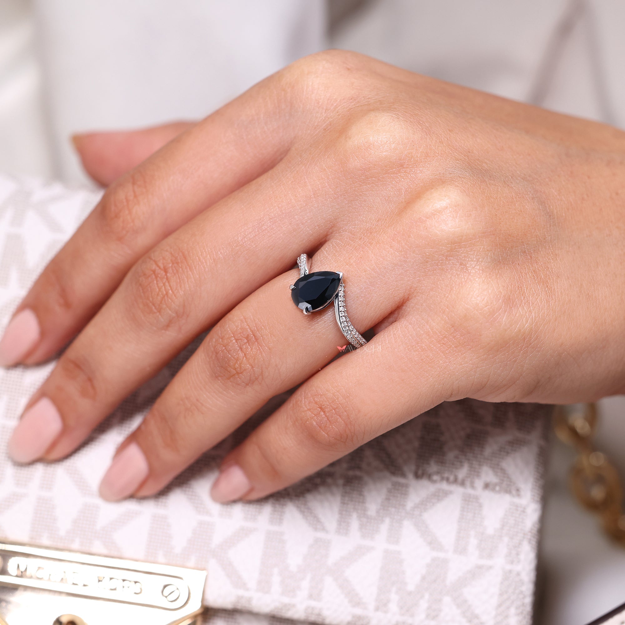 Pear cut moissanite ring featuring a brilliant, classic cut.