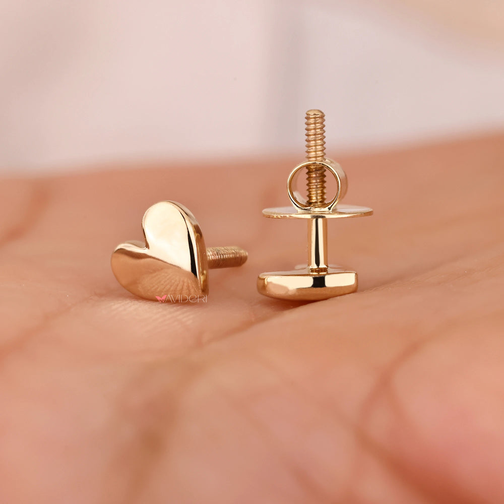 Screw back stud earrings with gold earrings.