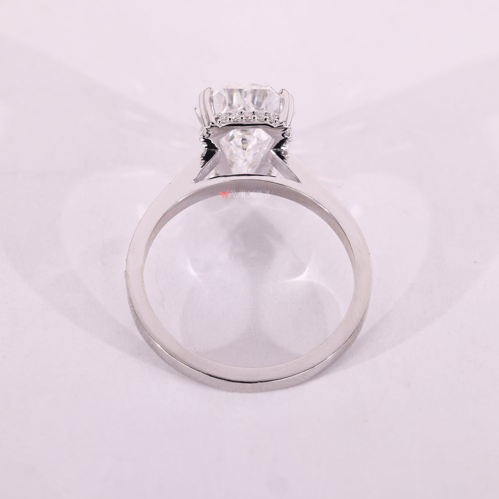 White gold ring with a coffin cut diamond and heart setting.