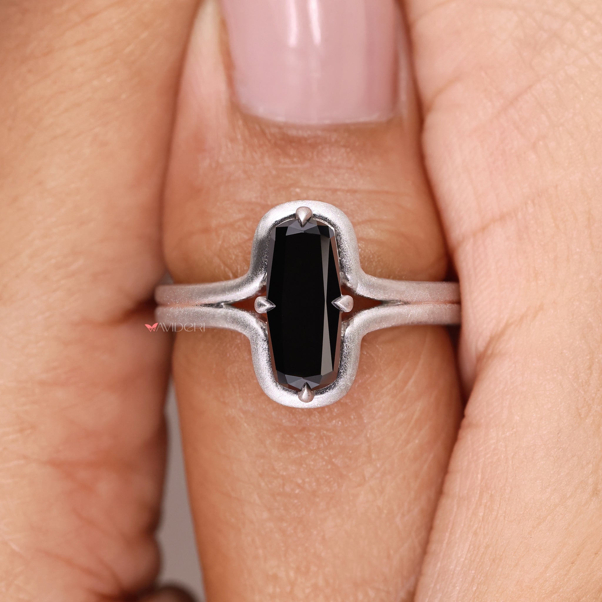 Handmade black stone ring set in a cushion cut white gold design
