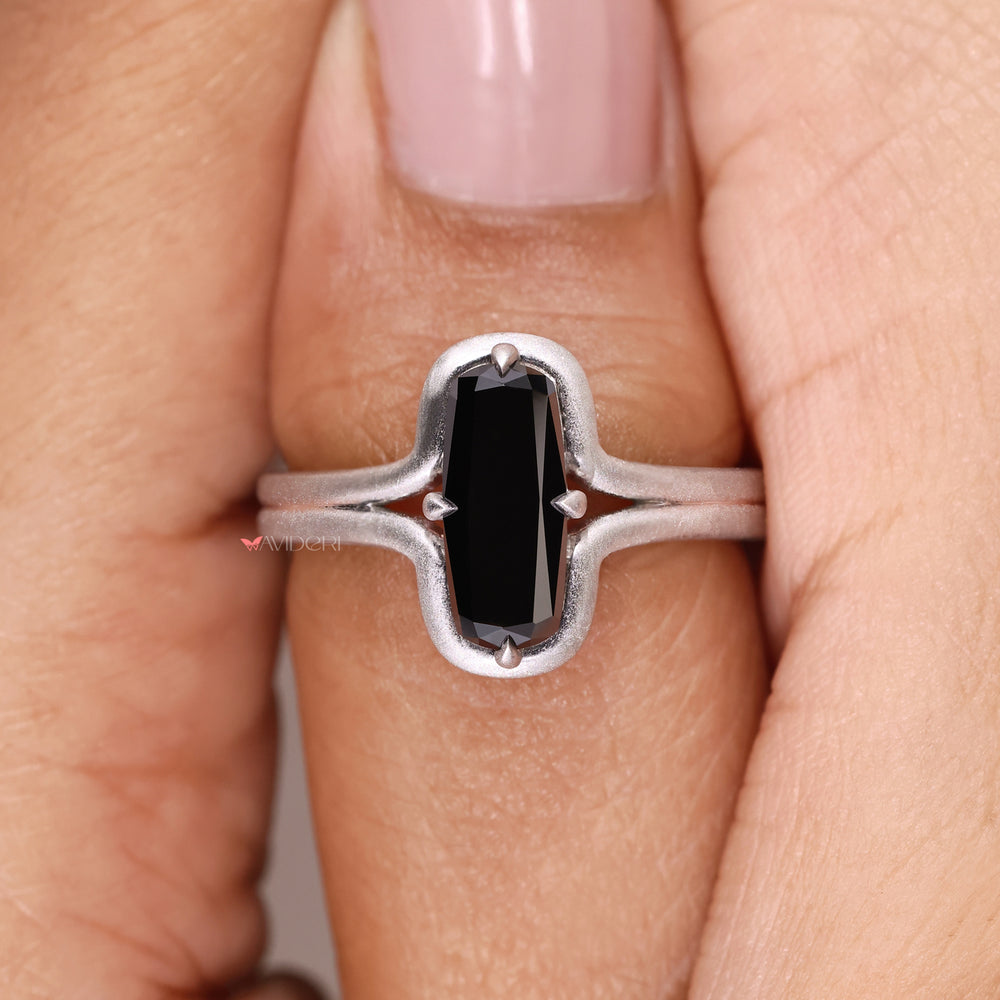 Handmade black stone ring set in a cushion cut white gold design
