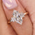 Marquise diamond engagement ring crafted with baguette and round side stones in yellow gold.
