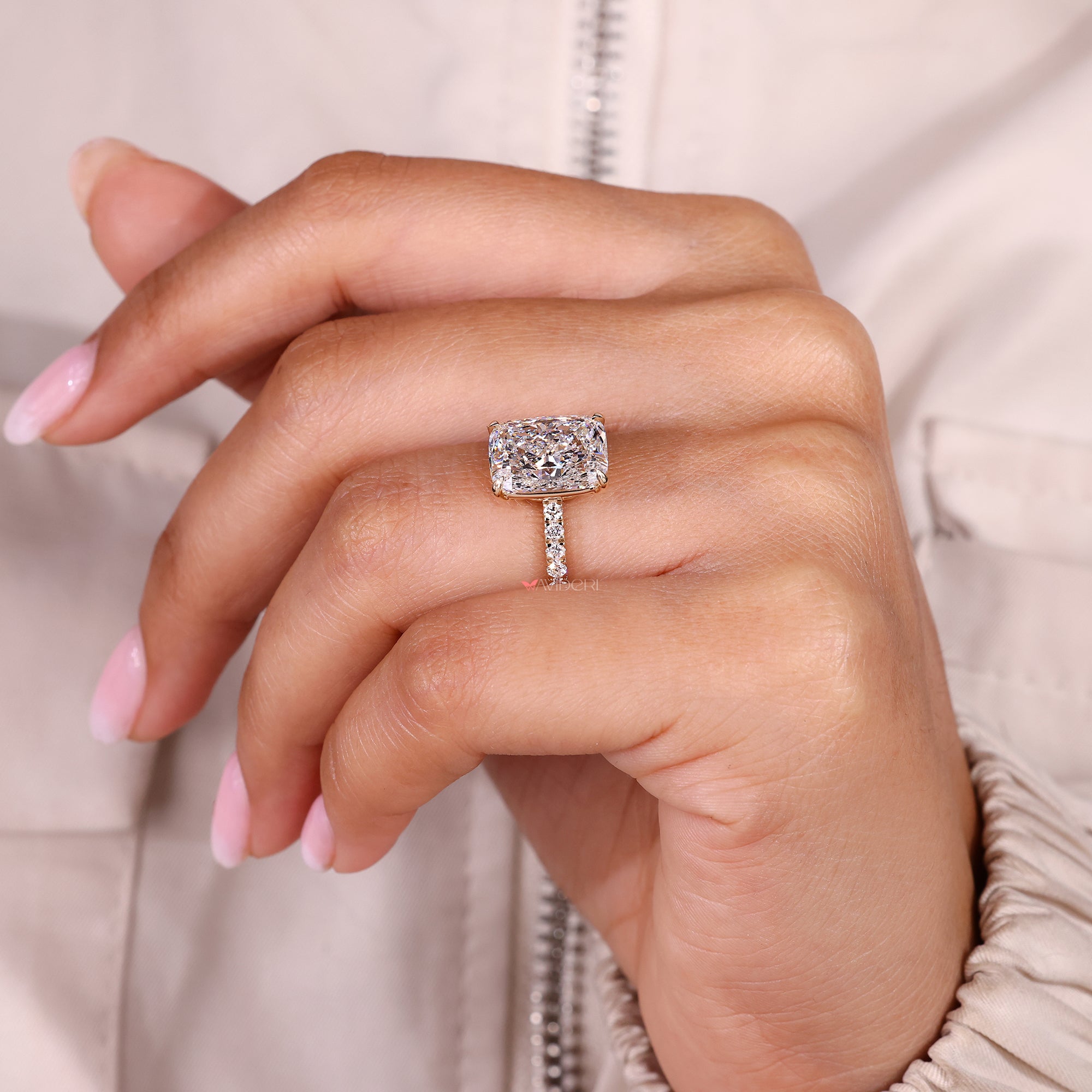 Lab grown cushion cut diamond ring with round pave band.
