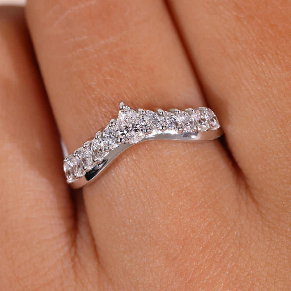 Curved diamond wedding band with a unique shape.
