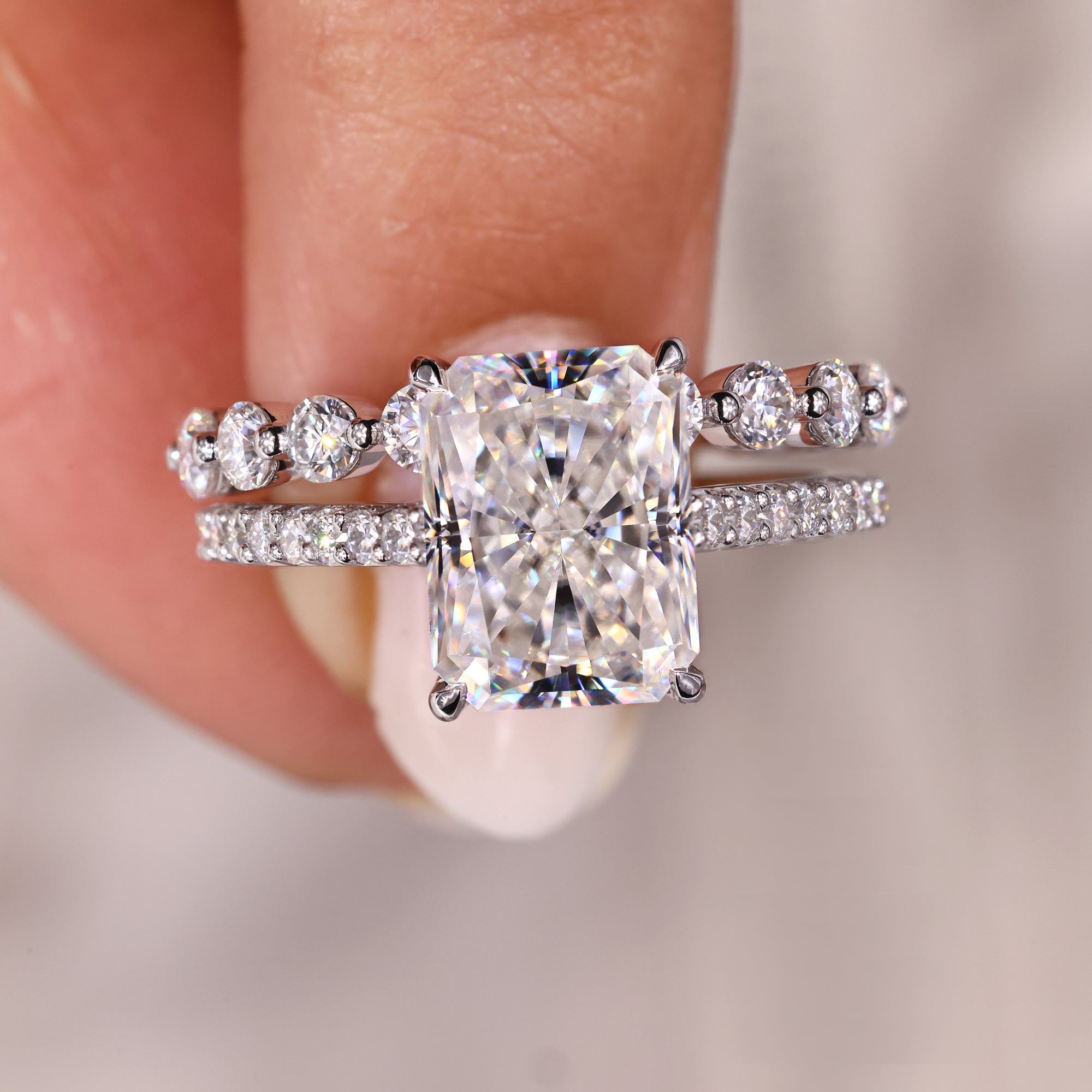 Custom white gold moissanite bridal set with claw prongs.