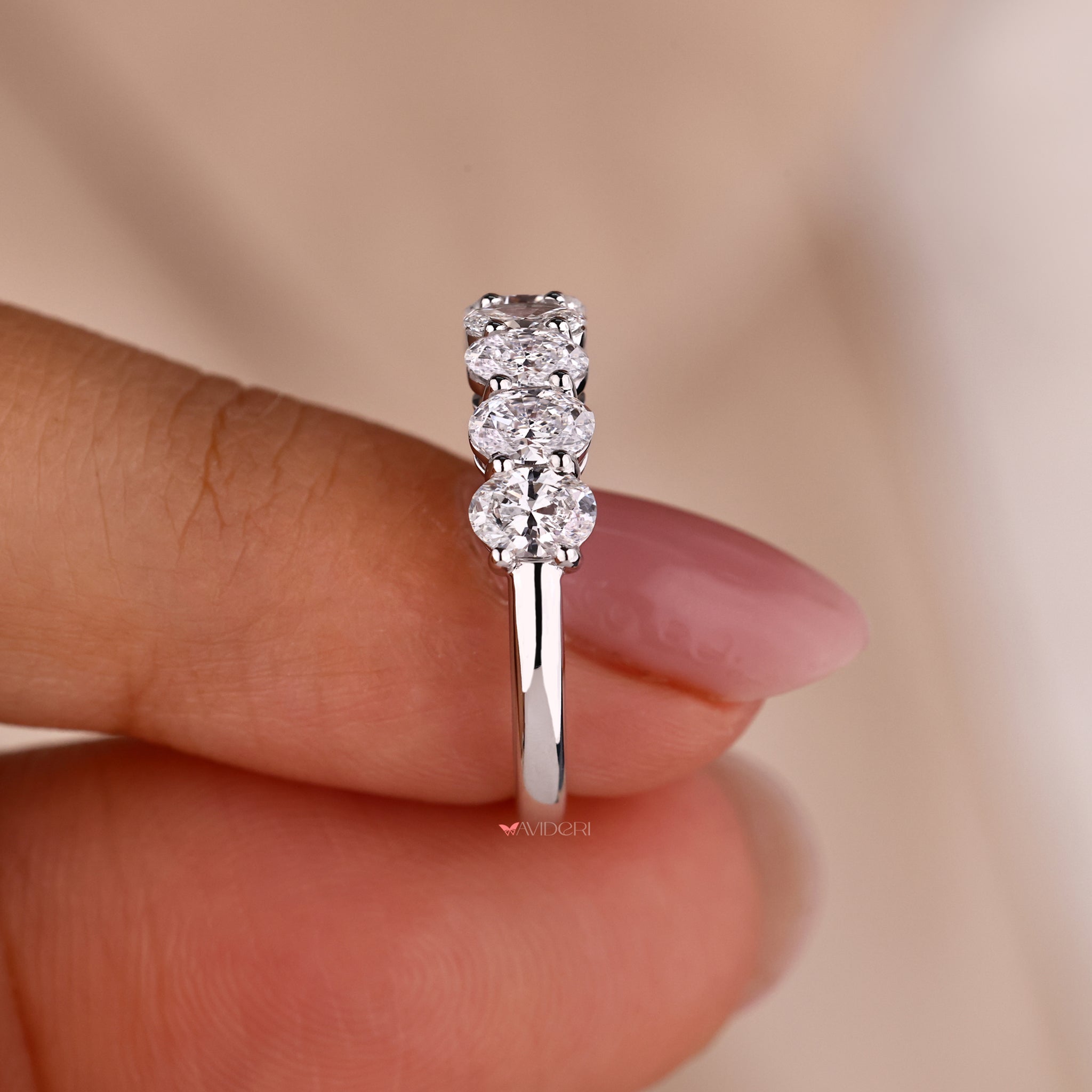 Shared prong wedding band with oval diamonds for a seamless look
