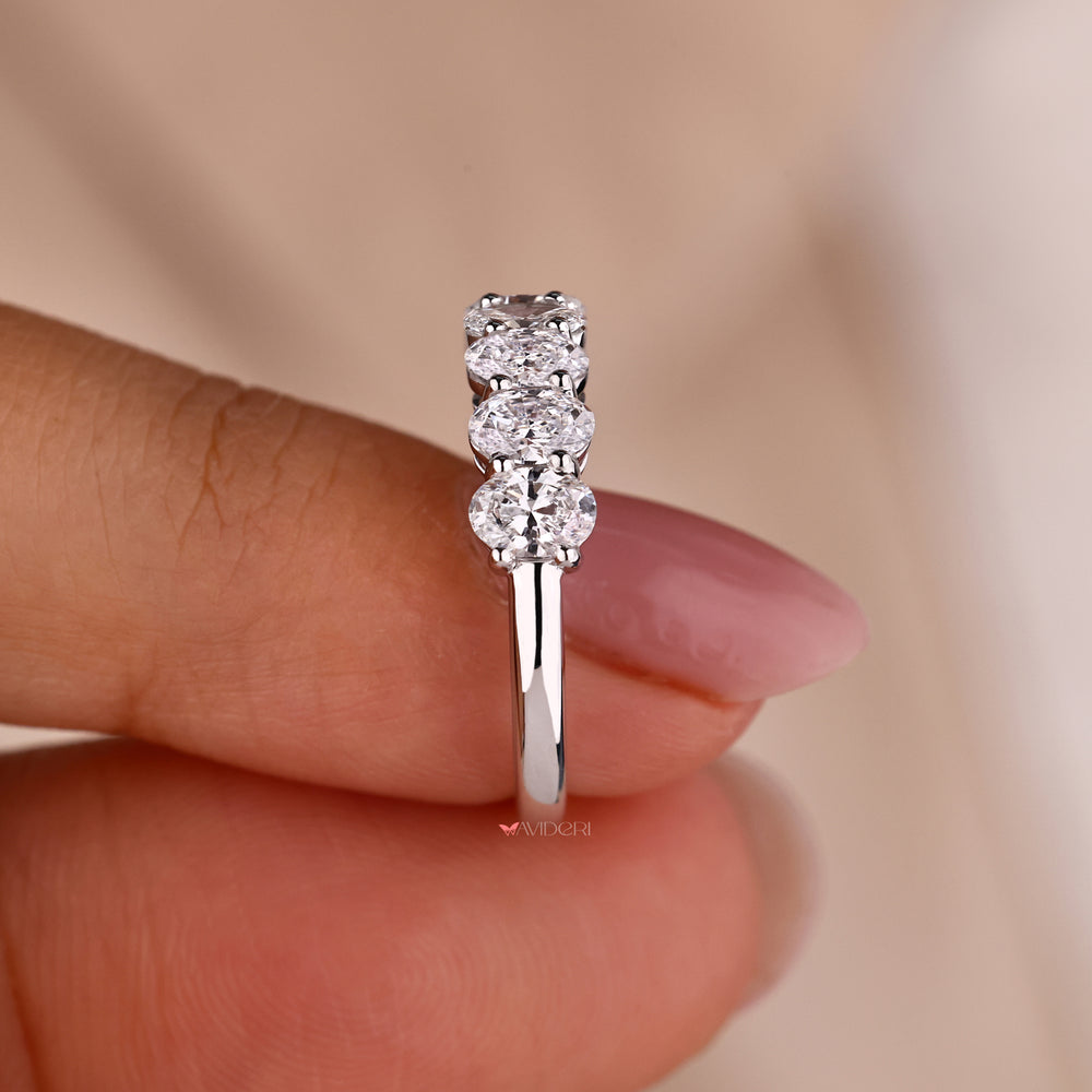 Shared prong wedding band with oval diamonds for a seamless look
