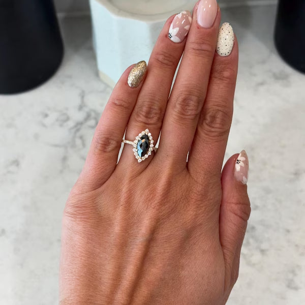 The ring is absolutely beautiful! I had them customize this ring in a marquise cut instead of the oval, and it turned out perfect. They were patient with my questions and requests. Great quality and craftsmanship.
