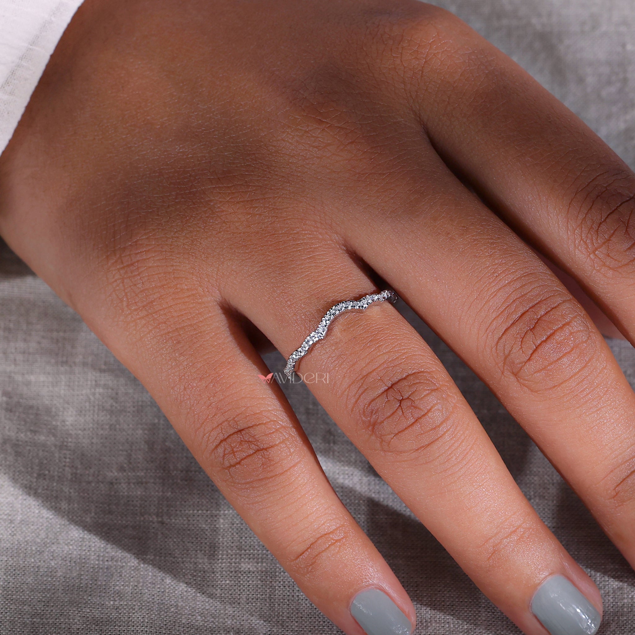 Curvy white gold wedding band for a distinct touch.
