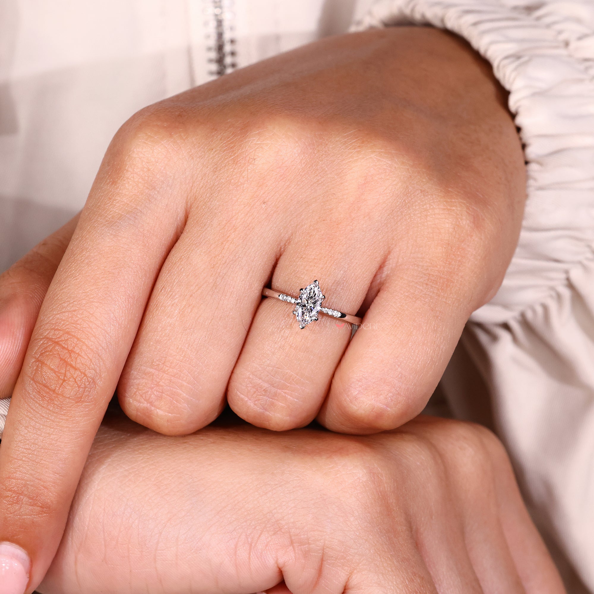 Buy engagement ring with marquise cut diamond and side stones.