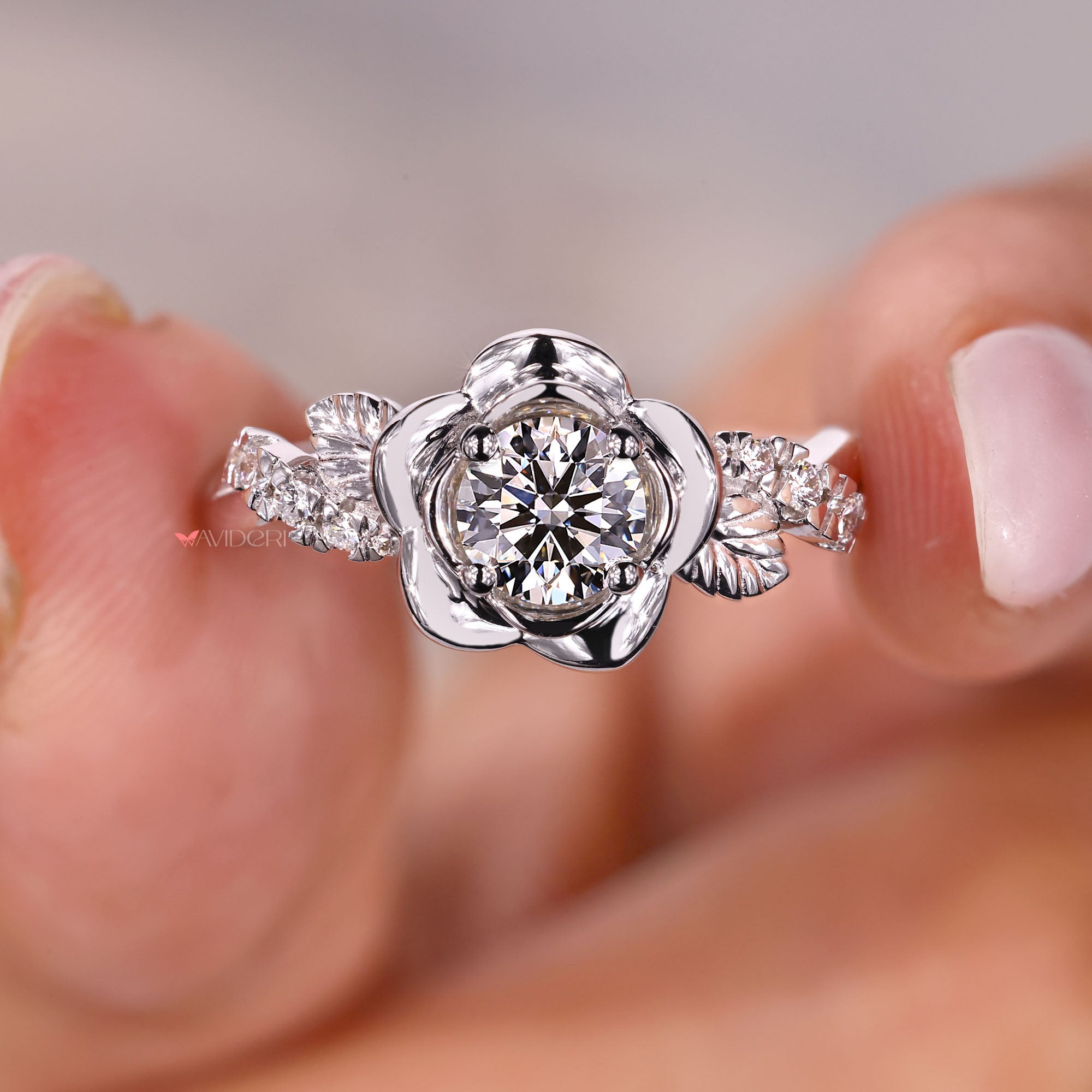 Four prong setting round diamond engagement ring in white gold.