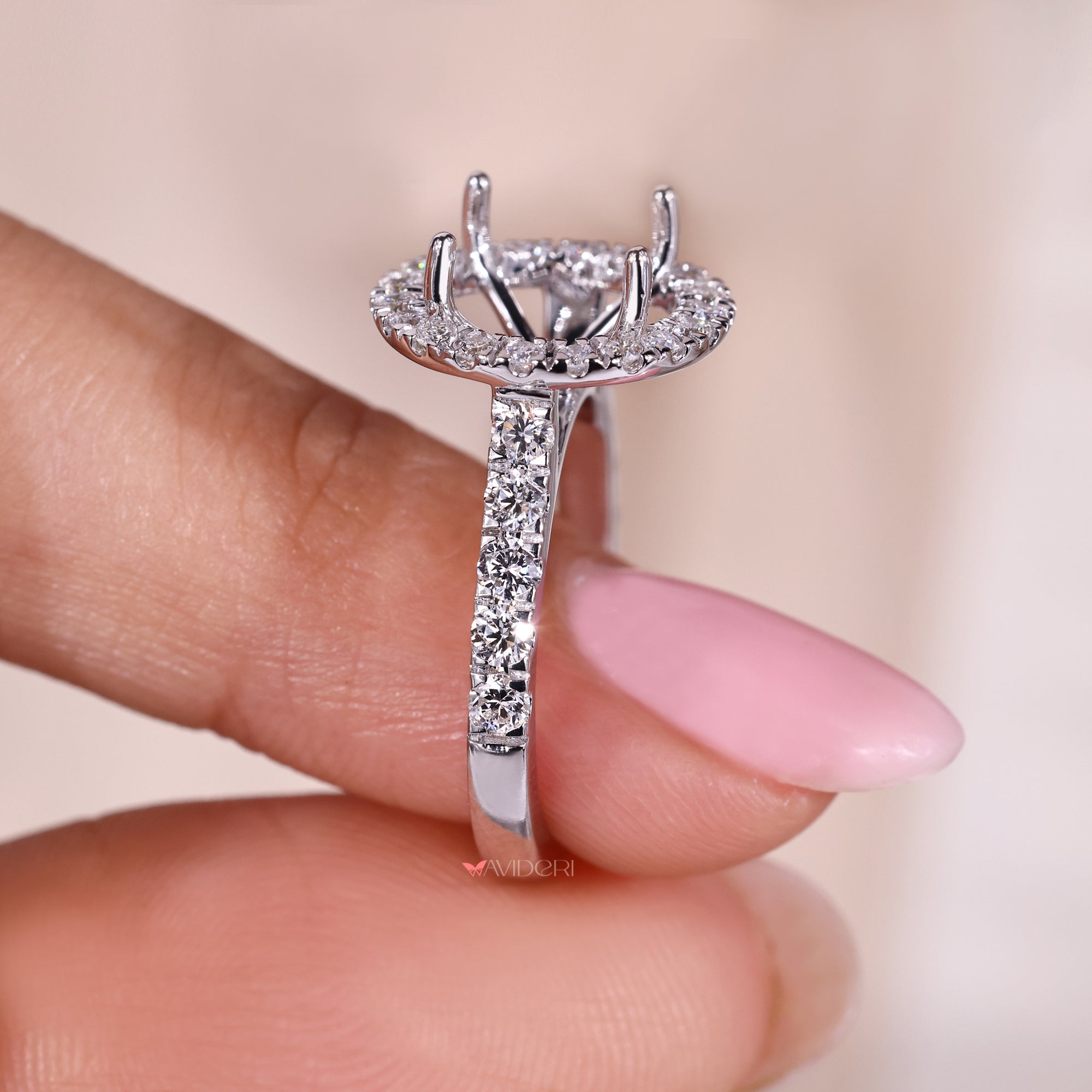 White gold halo engagement ring with round diamond accents.
