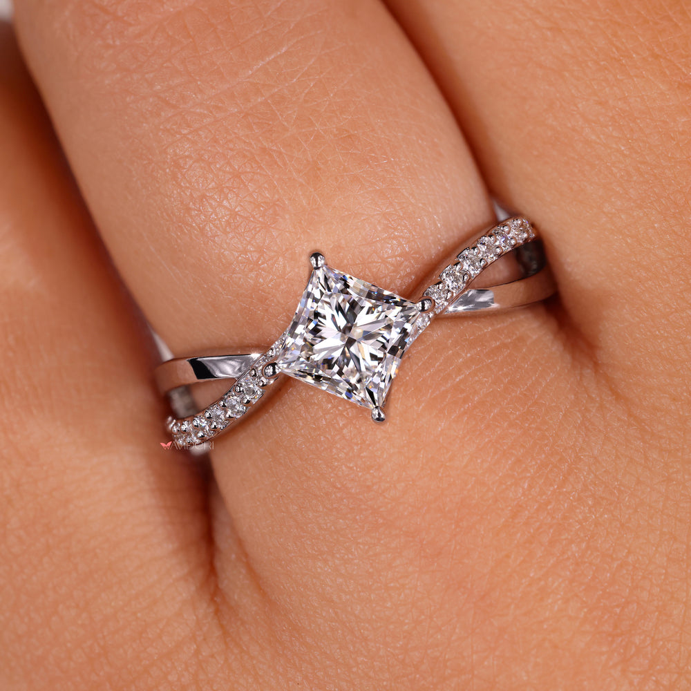 Twist engagement ring crafted with white gold and pave diamond accents for a modern look.
