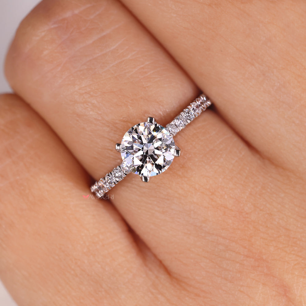 Buy engagement ring featuring a round diamond and pave setting for a bright look.
