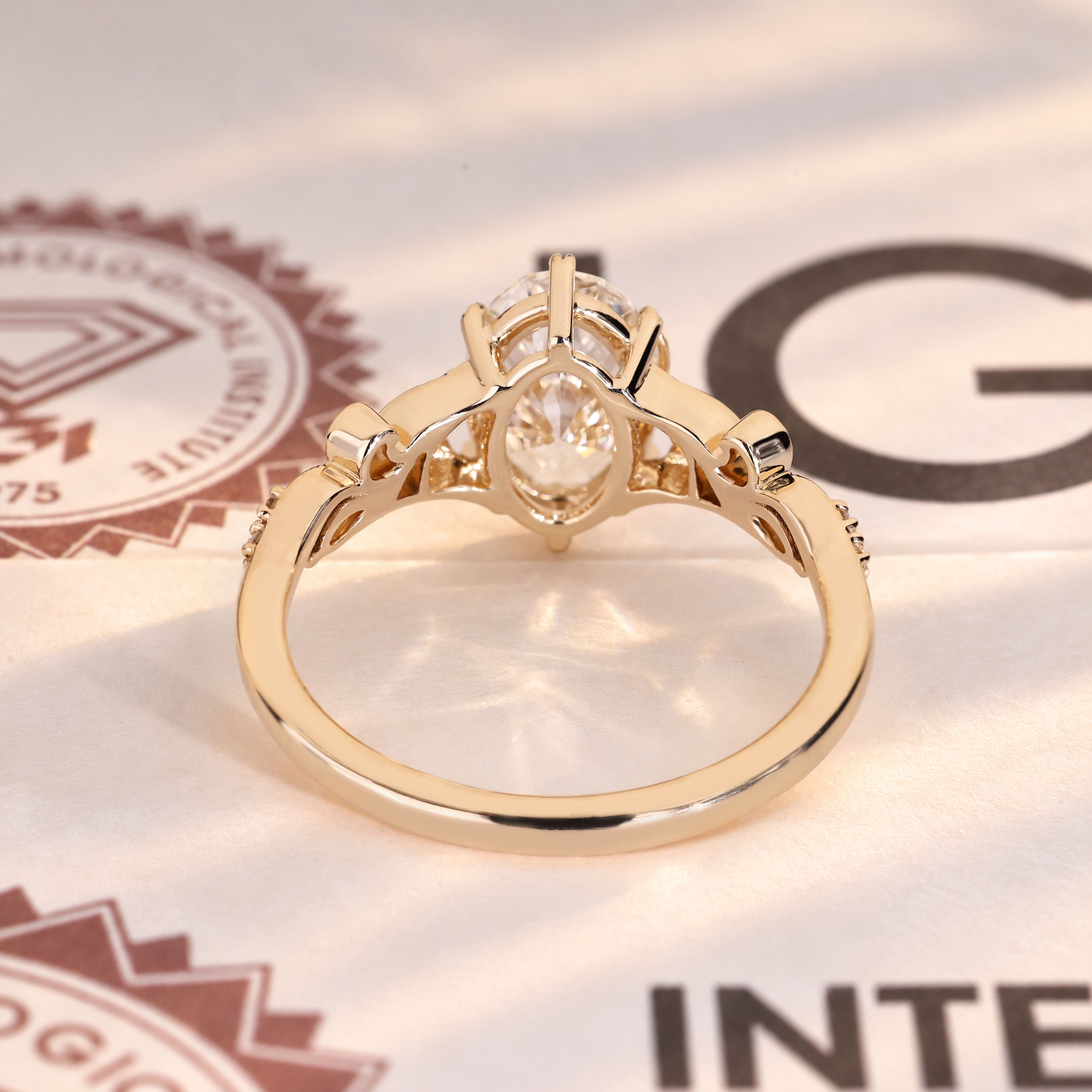 Oval diamond ring with marquise and round side stones.
