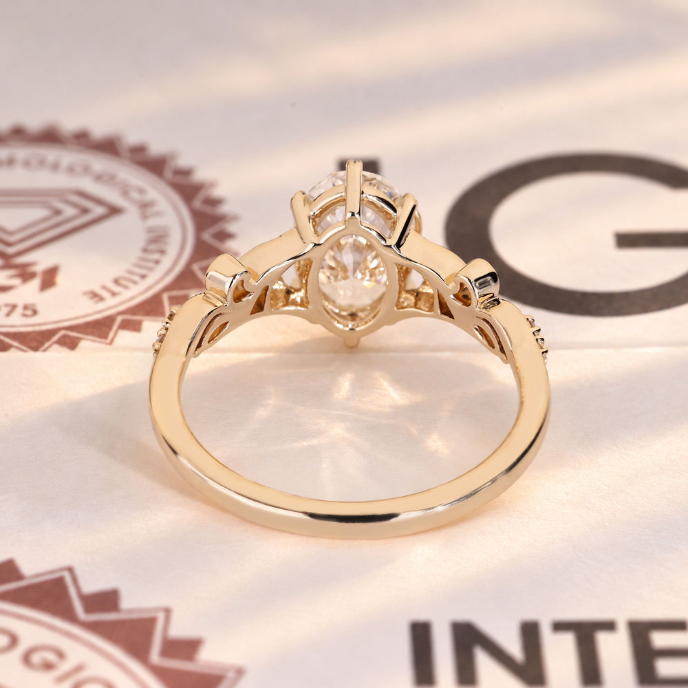 Oval diamond ring with marquise and round side stones.
