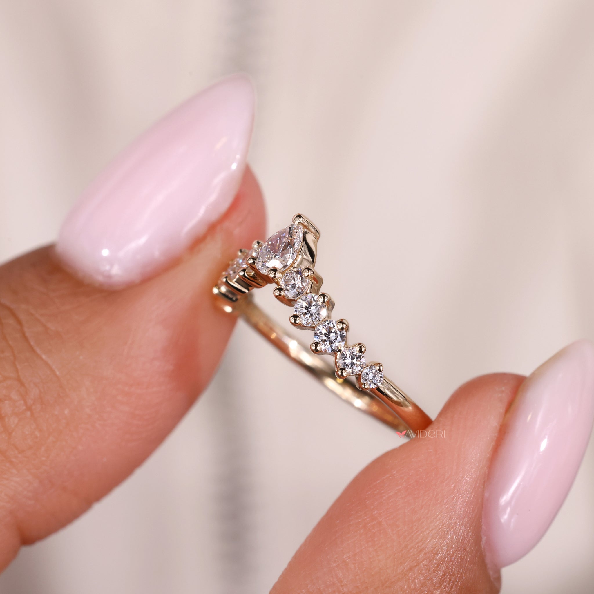Avideri engagement ring with pear shaped diamond band for an elegant design.
