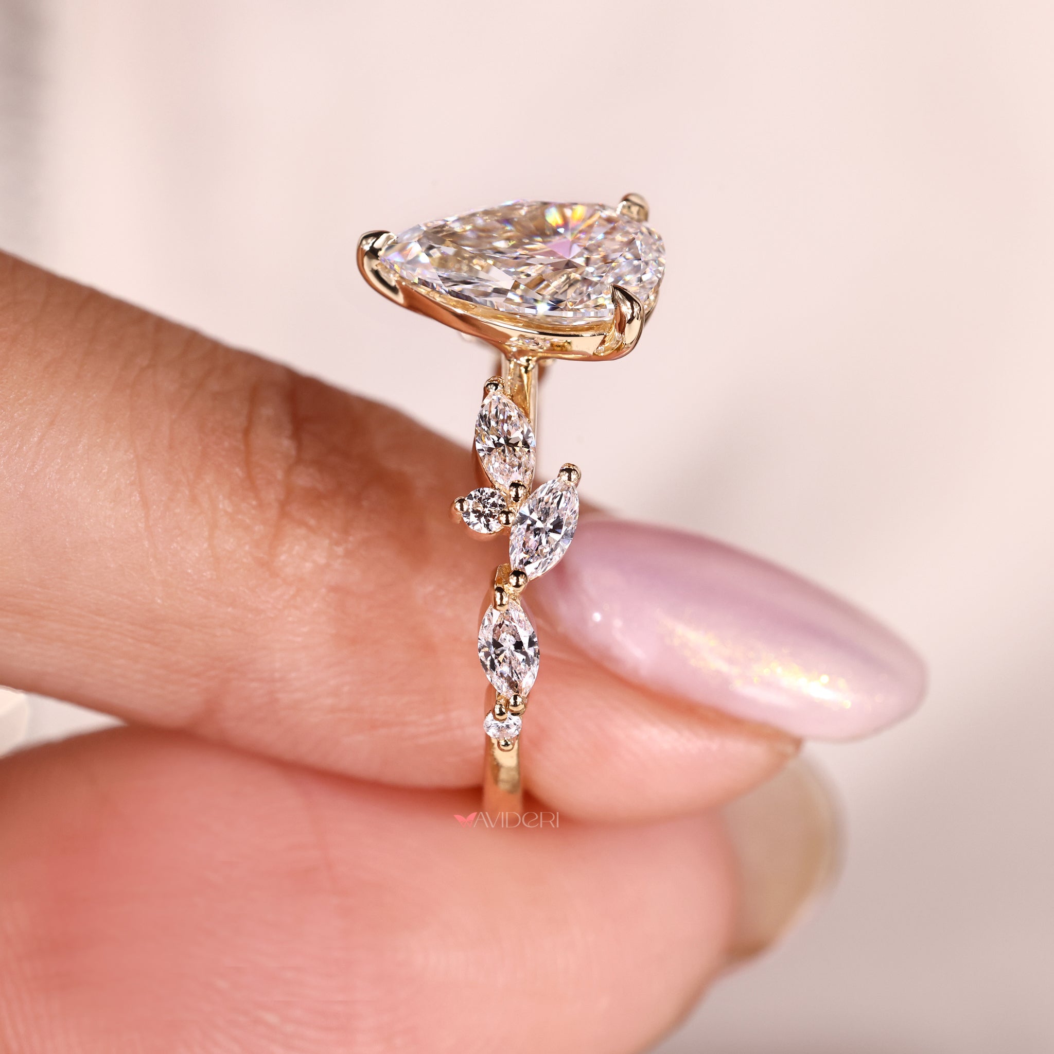 Pear diamond engagement ring crafted in a three prong setting with a tapered shank.
