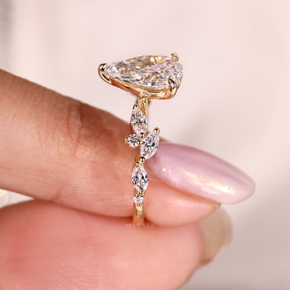 Pear diamond engagement ring crafted in a three prong setting with a tapered shank.
