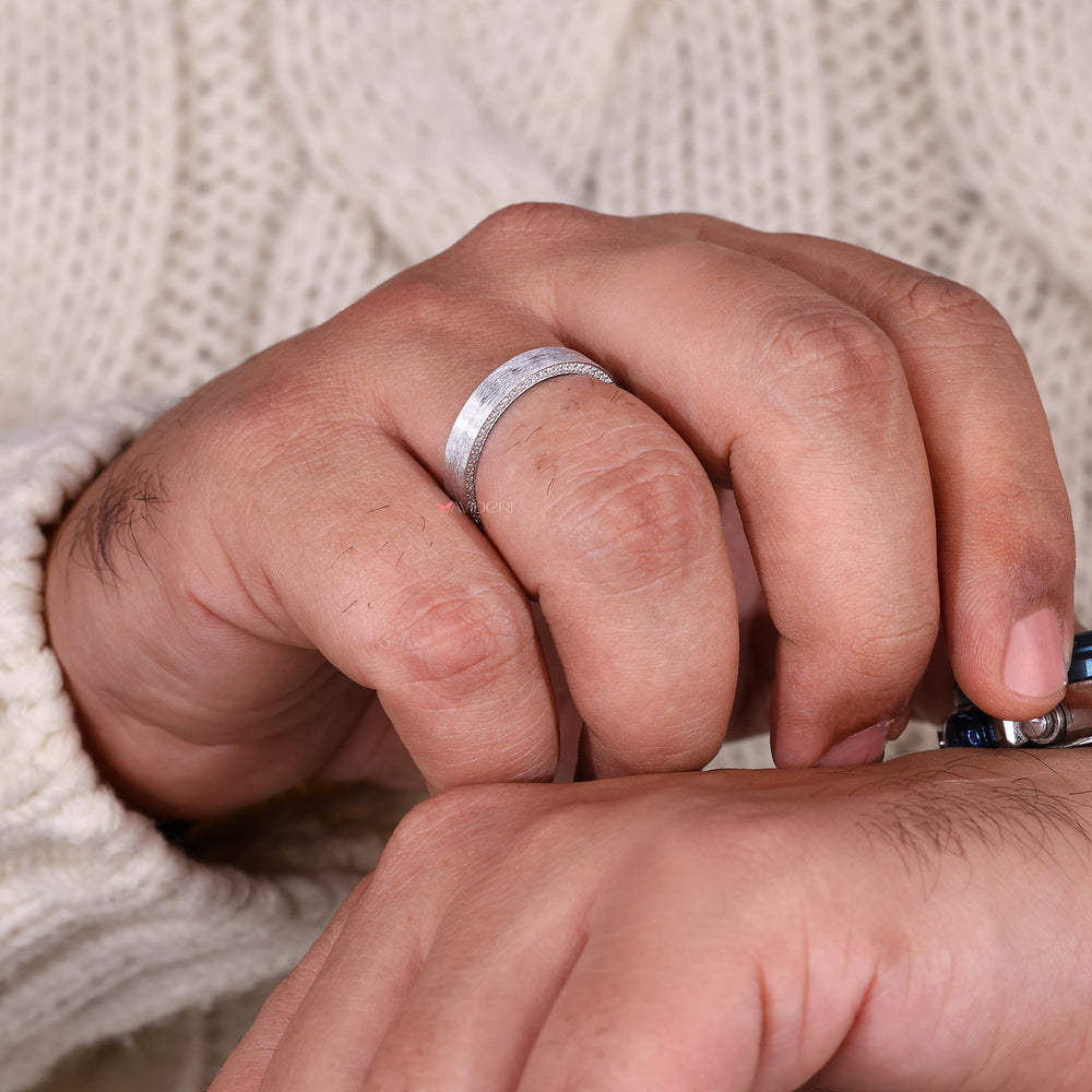 Brush finish ring with a diamond band.
