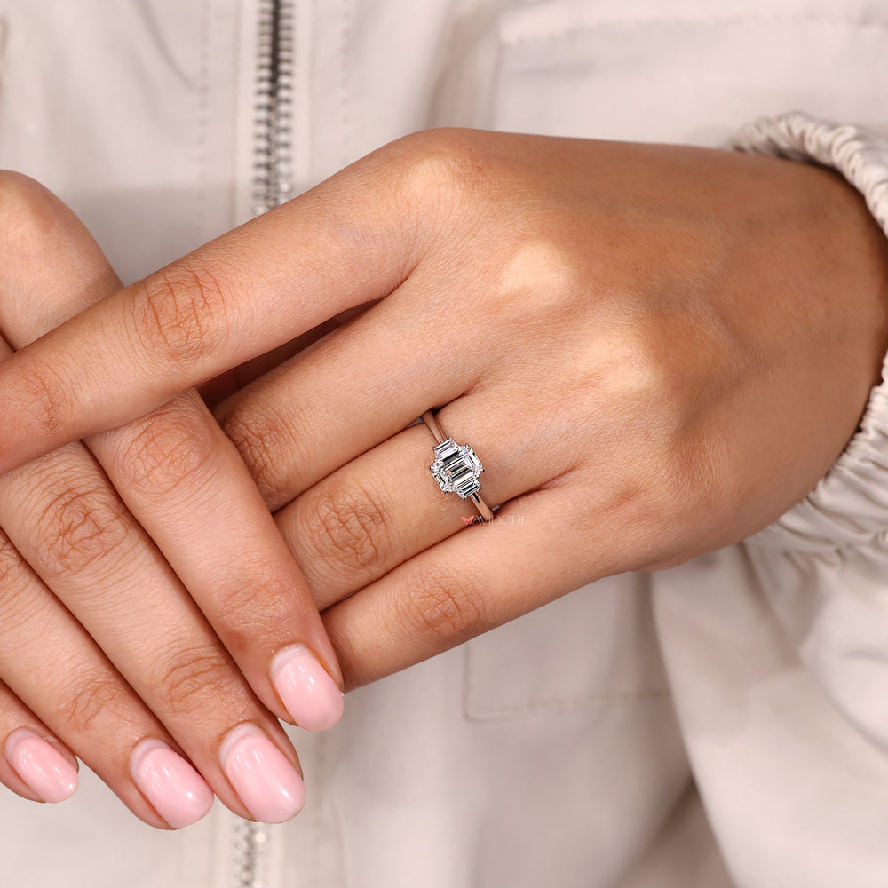 Avideri engagement ring with emerald cut center and trapezoid side diamonds.