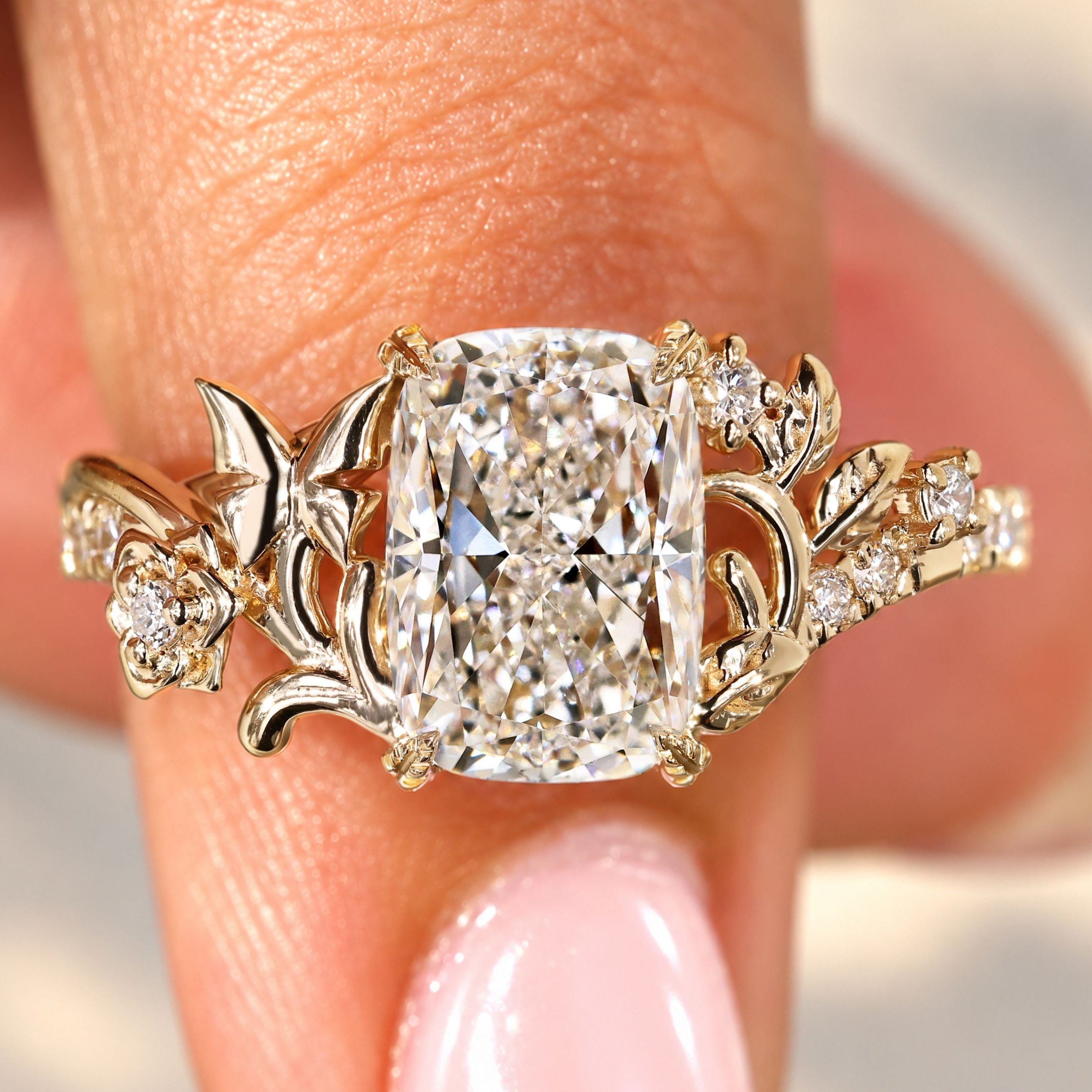 Cushion cut diamond ring with round diamond pave.

