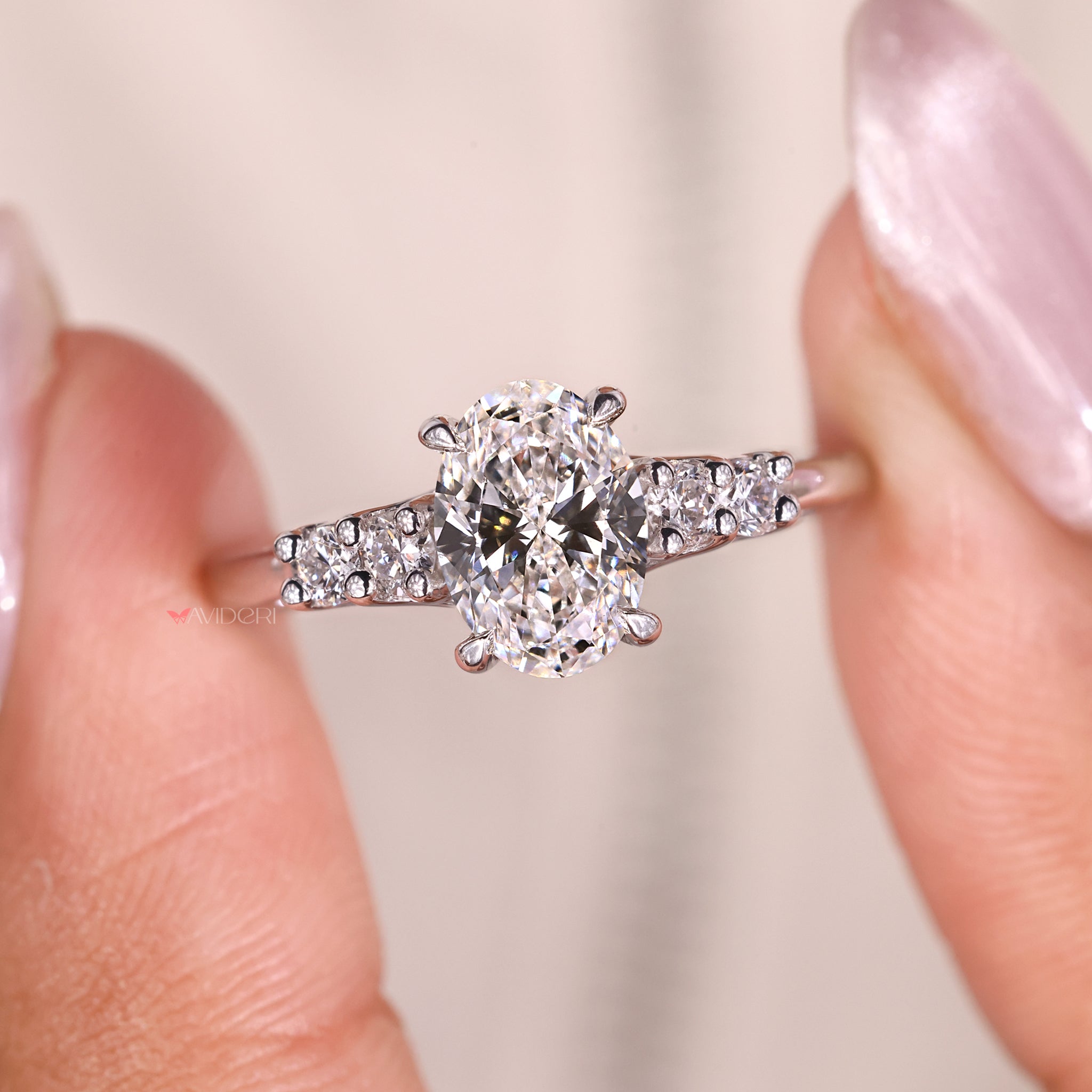 Custom engagement ring handmade by Avideri in a unique oval and side stone setting.
