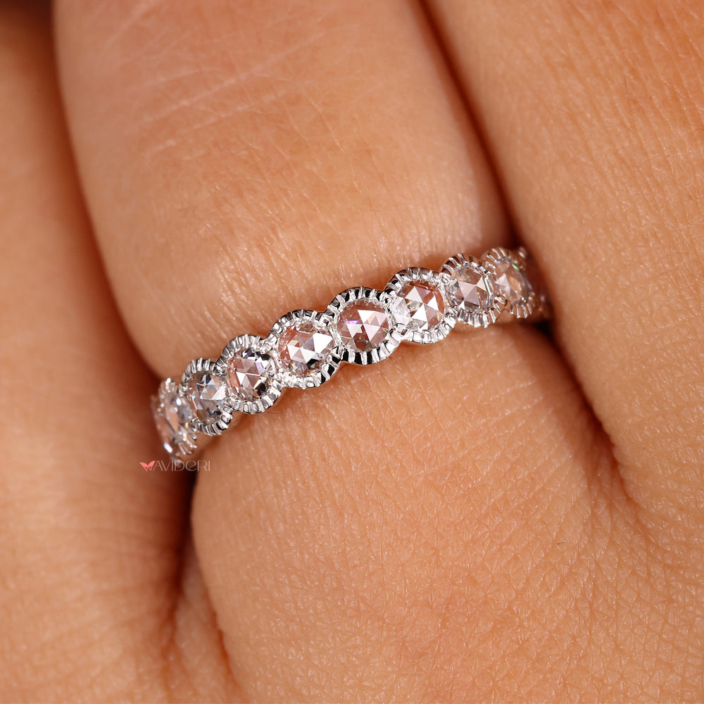 Half eternity band featuring a milgrain wedding band with round diamonds.
