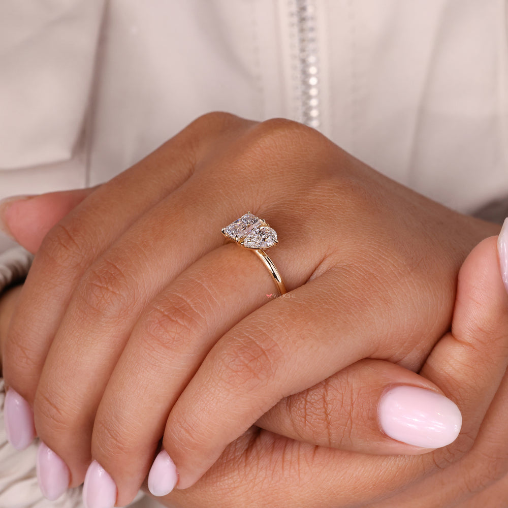 Toi et moi engagement ring featuring a pear shaped diamond for a bold statement.
